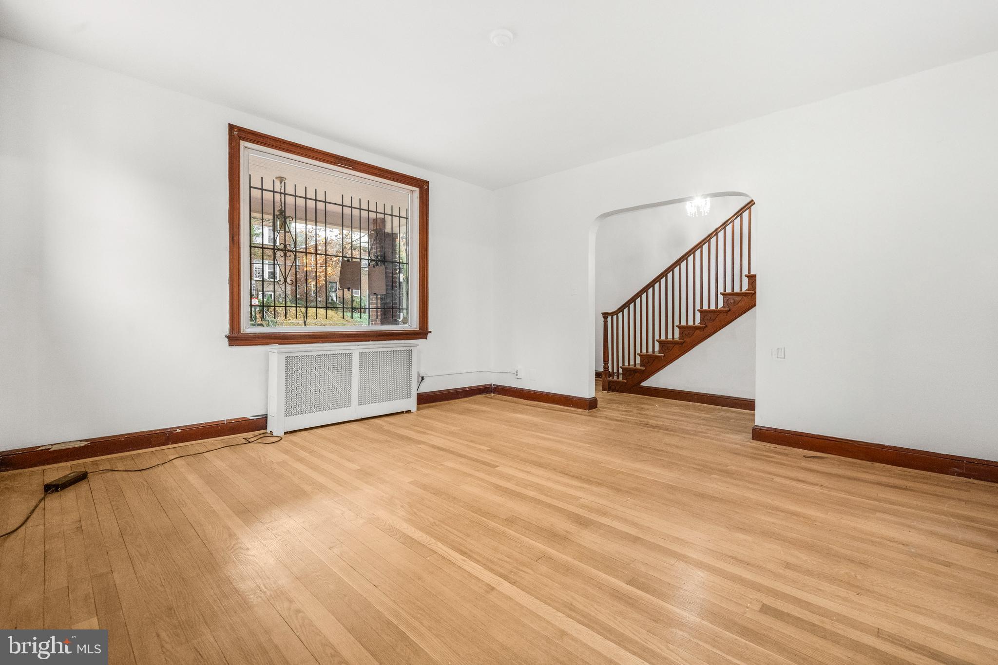 4108 Grant Street Northeast Washington, DC 20019 - Photo 5 of 31 a view of an empty room with wooden floor and a window