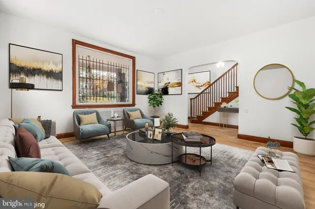 a living room with furniture a lamp and a potted plant