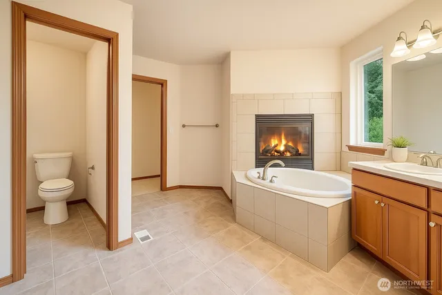 a large bathroom with a double vanity sink a mirror and a bathtub