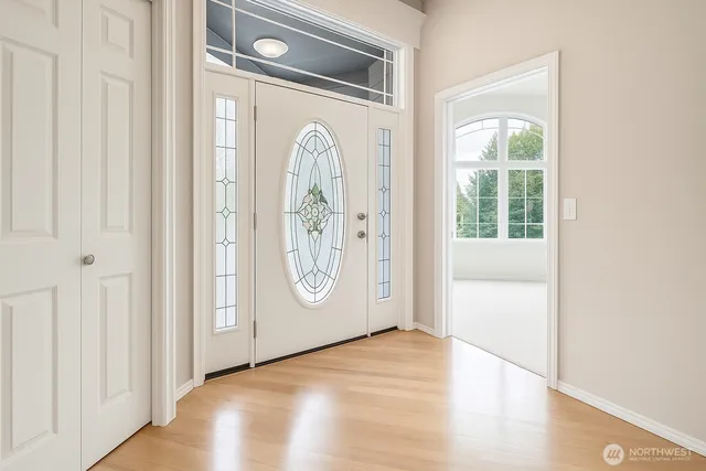 a living room with furniture and large windows