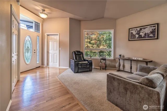 a living room with furniture and wooden floor