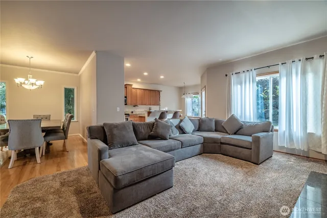 a living room with furniture and a view of kitchen