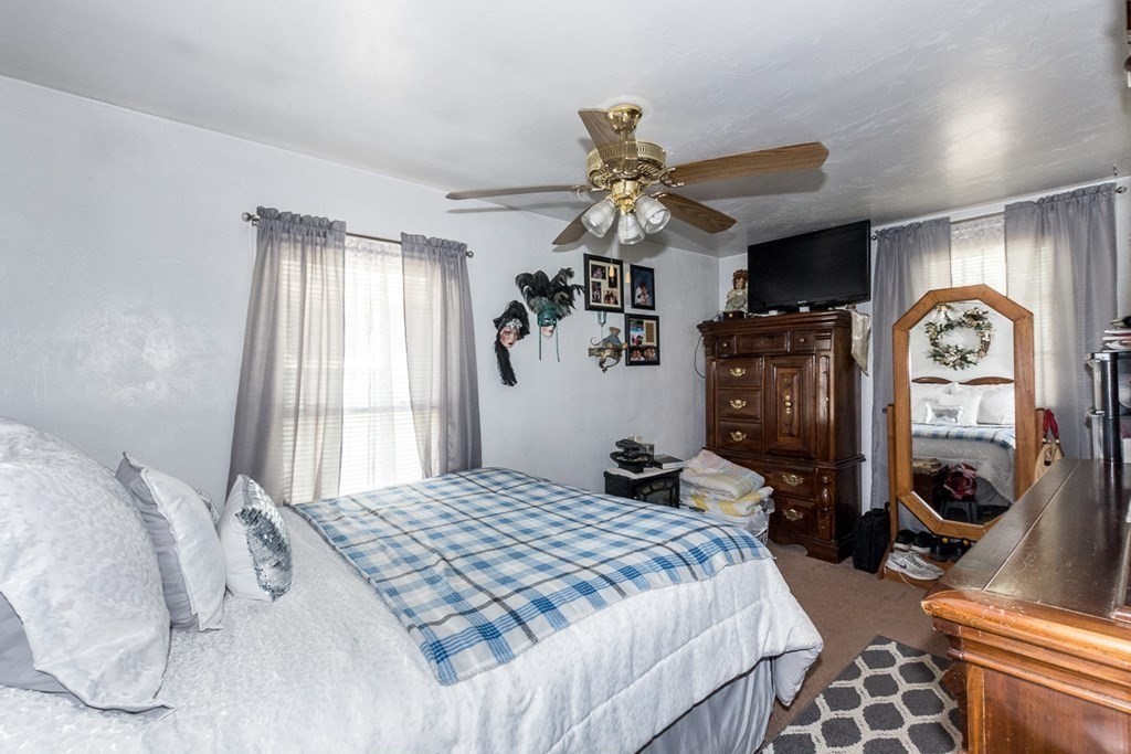 21 Victoria Avenue Rutland, MA 01543 - Photo 11 of 15 a bedroom with a bed a clock on the wall and dresser
