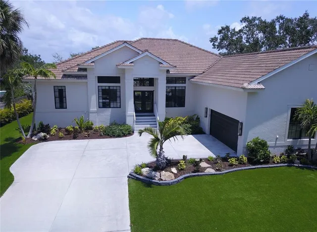 a front view of a house with a garden and plants
