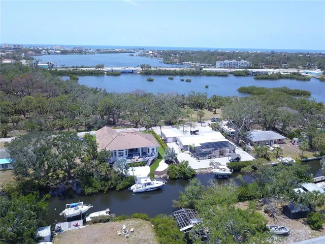 an aerial view of a city with lots of residential buildings and mountain view in back