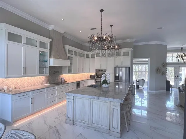 a kitchen with center island table and chairs in it