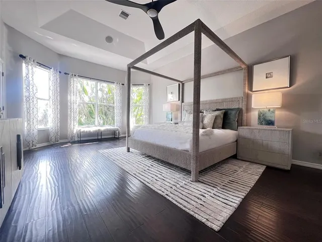 a bedroom with a bed and a large window