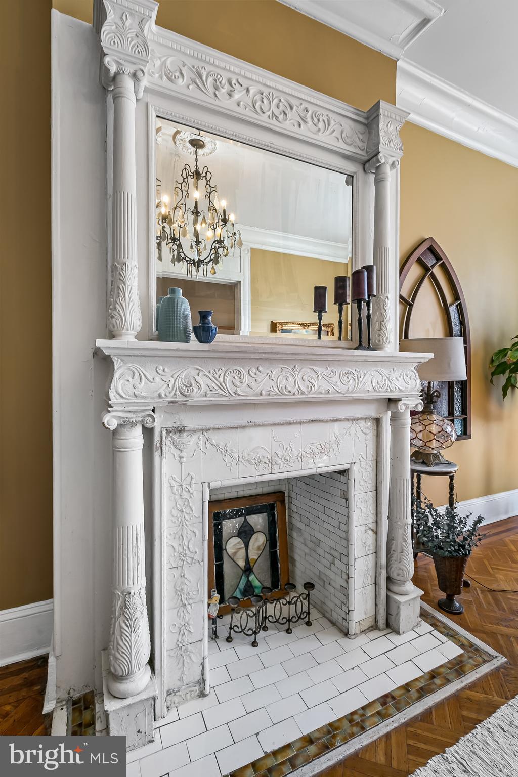 2243 Eutaw Place Baltimore, MD 21217 - Photo 13 of 54 a living room with furniture a fireplace and a floor to ceiling window