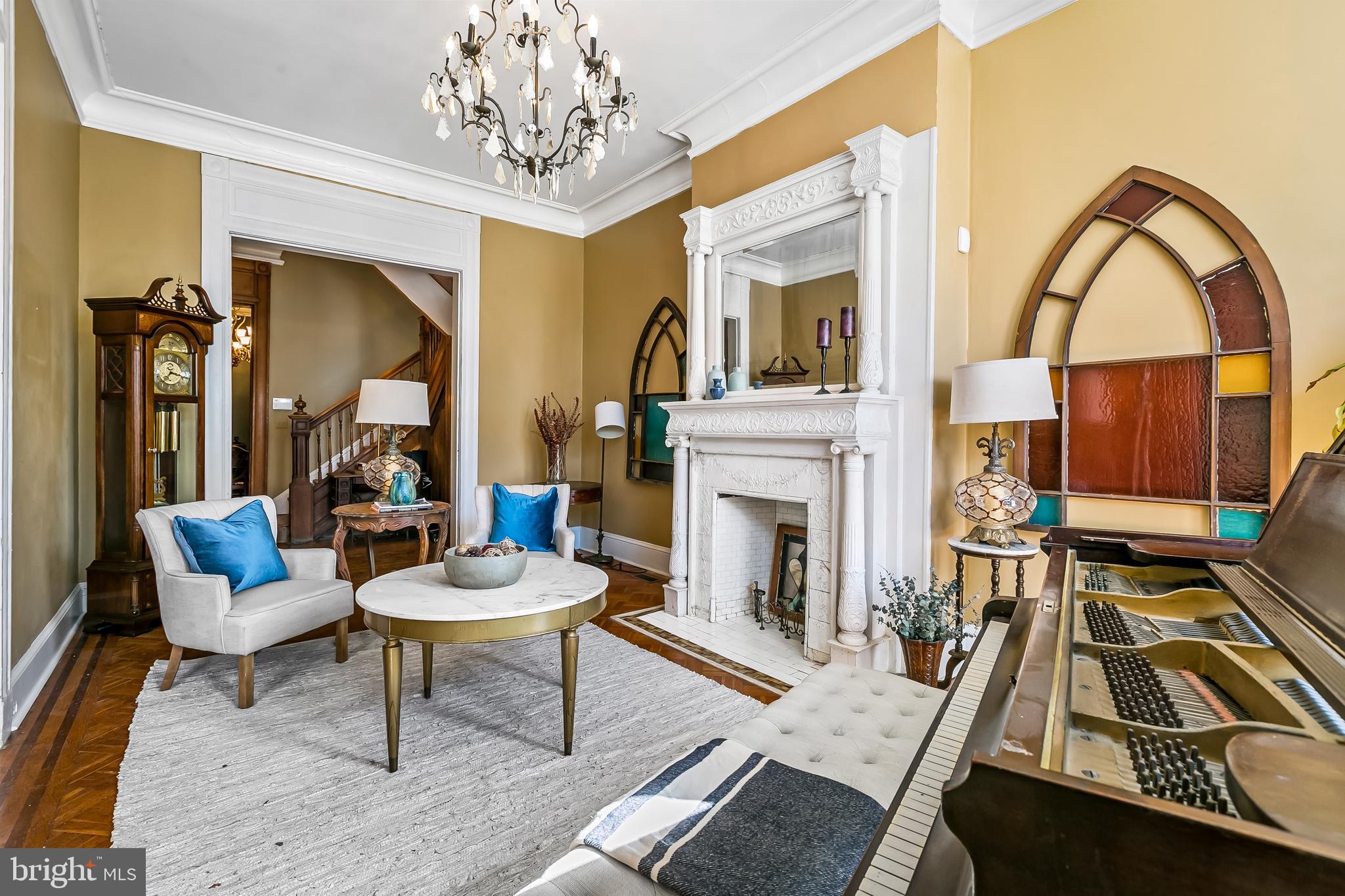 2243 Eutaw Place Baltimore, MD 21217 - Photo 14 of 54 a living room with furniture a fireplace and a chandelier