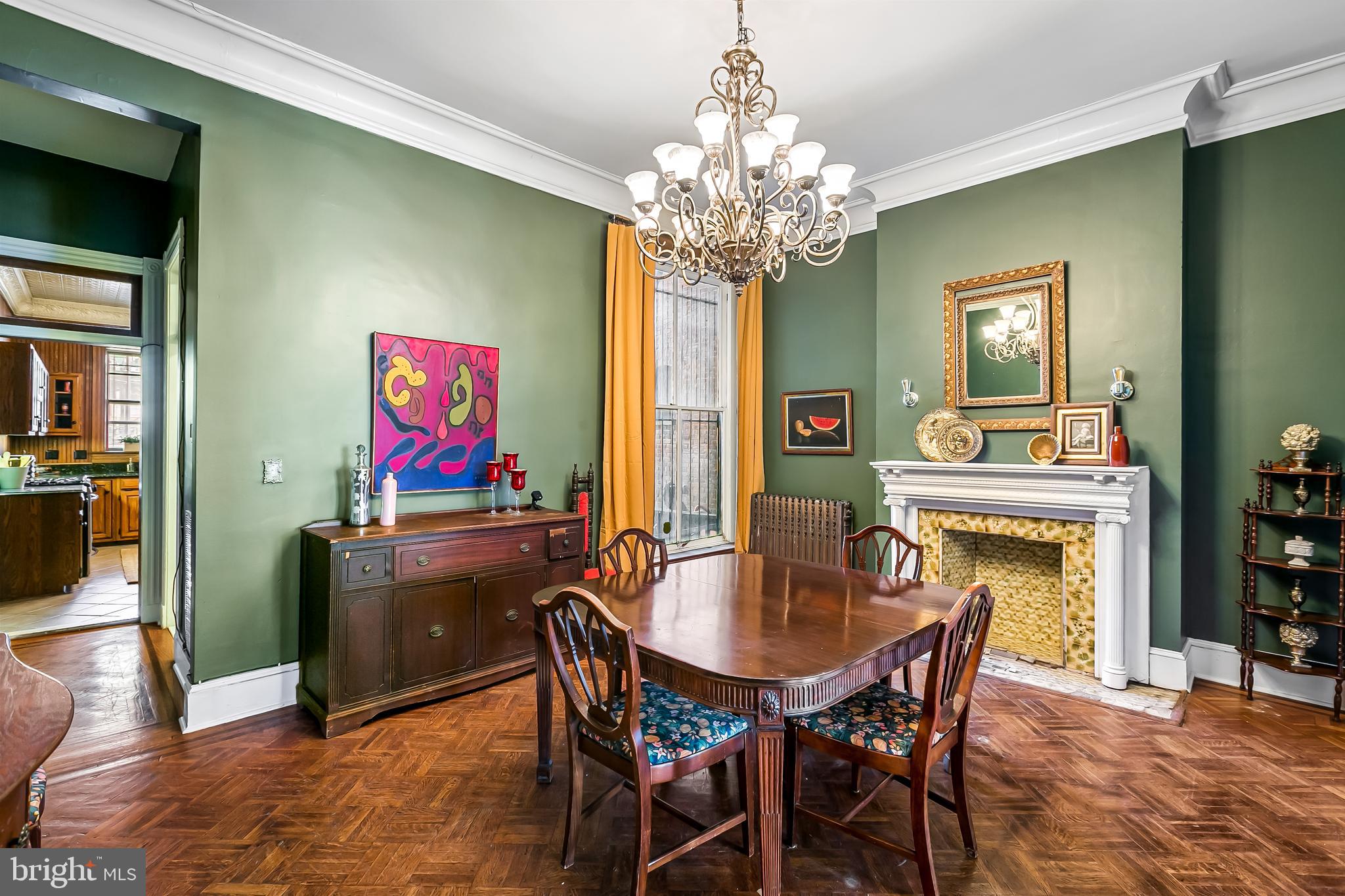 2243 Eutaw Place Baltimore, MD 21217 - Photo 20 of 54 a dining room with furniture a chandelier and wooden floor