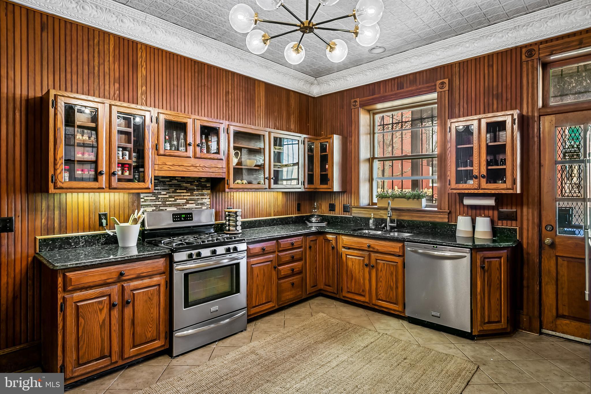 2243 Eutaw Place Baltimore, MD 21217 - Photo 23 of 54 a kitchen with stainless steel appliances granite countertop a stove and cabinets