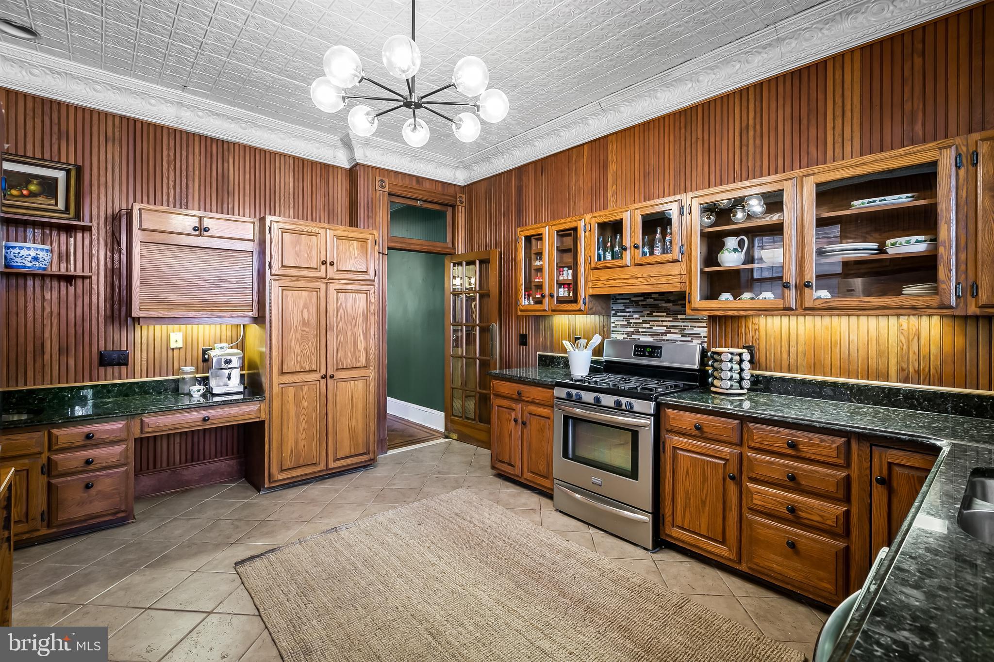 2243 Eutaw Place Baltimore, MD 21217 - Photo 25 of 54 a kitchen with stainless steel appliances granite countertop a stove refrigerator and cabinets
