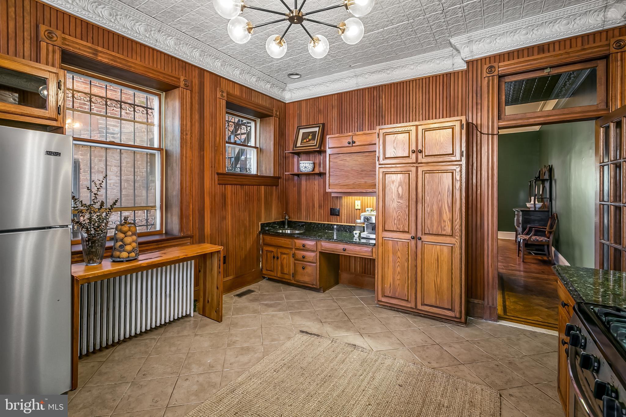 2243 Eutaw Place Baltimore, MD 21217 - Photo 26 of 54 a kitchen with stainless steel appliances granite countertop a refrigerator and a stove top oven