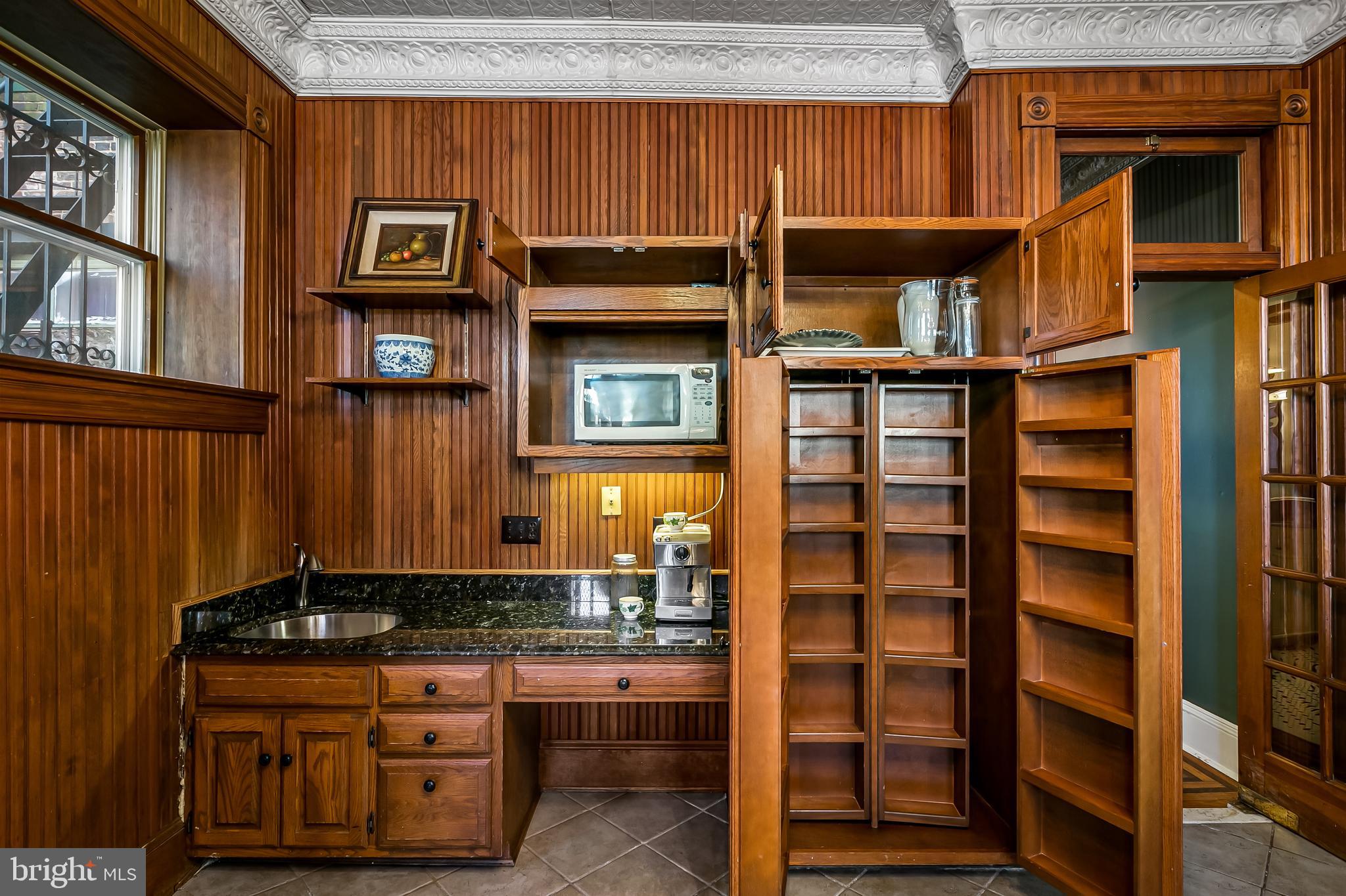 2243 Eutaw Place Baltimore, MD 21217 - Photo 28 of 54 a kitchen with stainless steel appliances granite countertop a stove and cabinets