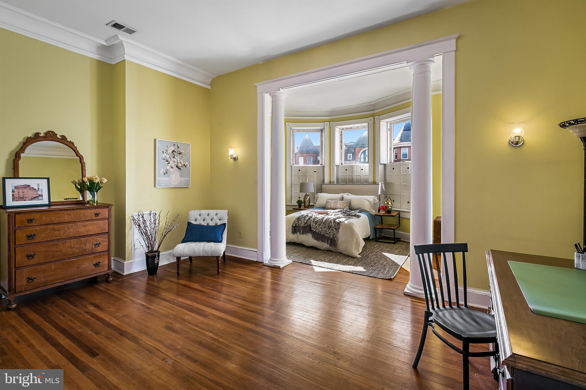 2243 Eutaw Place Baltimore, MD 21217 - Photo 33 of 54 a bedroom with a bed and wooden floor