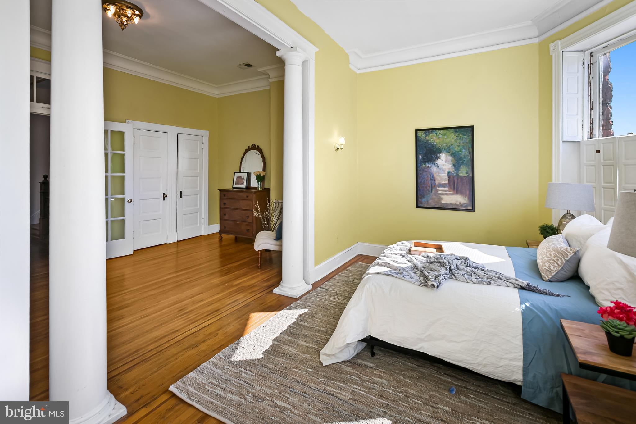 2243 Eutaw Place Baltimore, MD 21217 - Photo 36 of 54 a bedroom with a bed and wooden floor