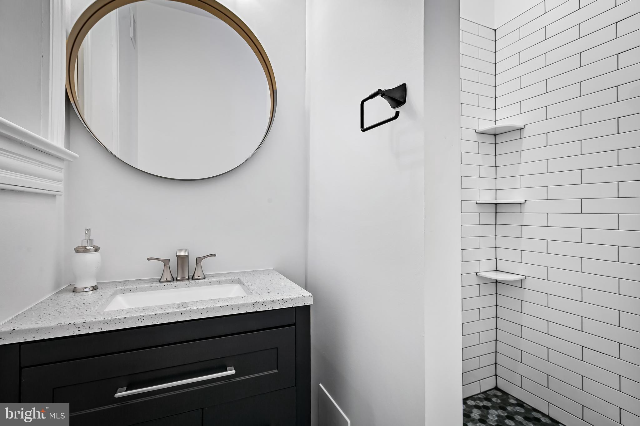 2243 Eutaw Place Baltimore, MD 21217 - Photo 39 of 54 a bathroom with a sink and a mirror