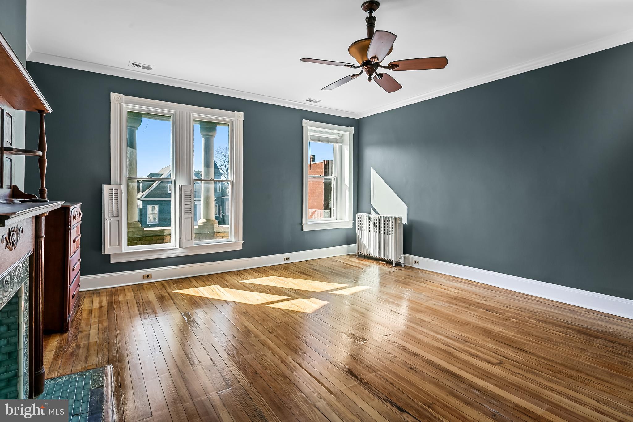 2243 Eutaw Place Baltimore, MD 21217 - Photo 42 of 54 a view of an empty room with a window and wooden floor