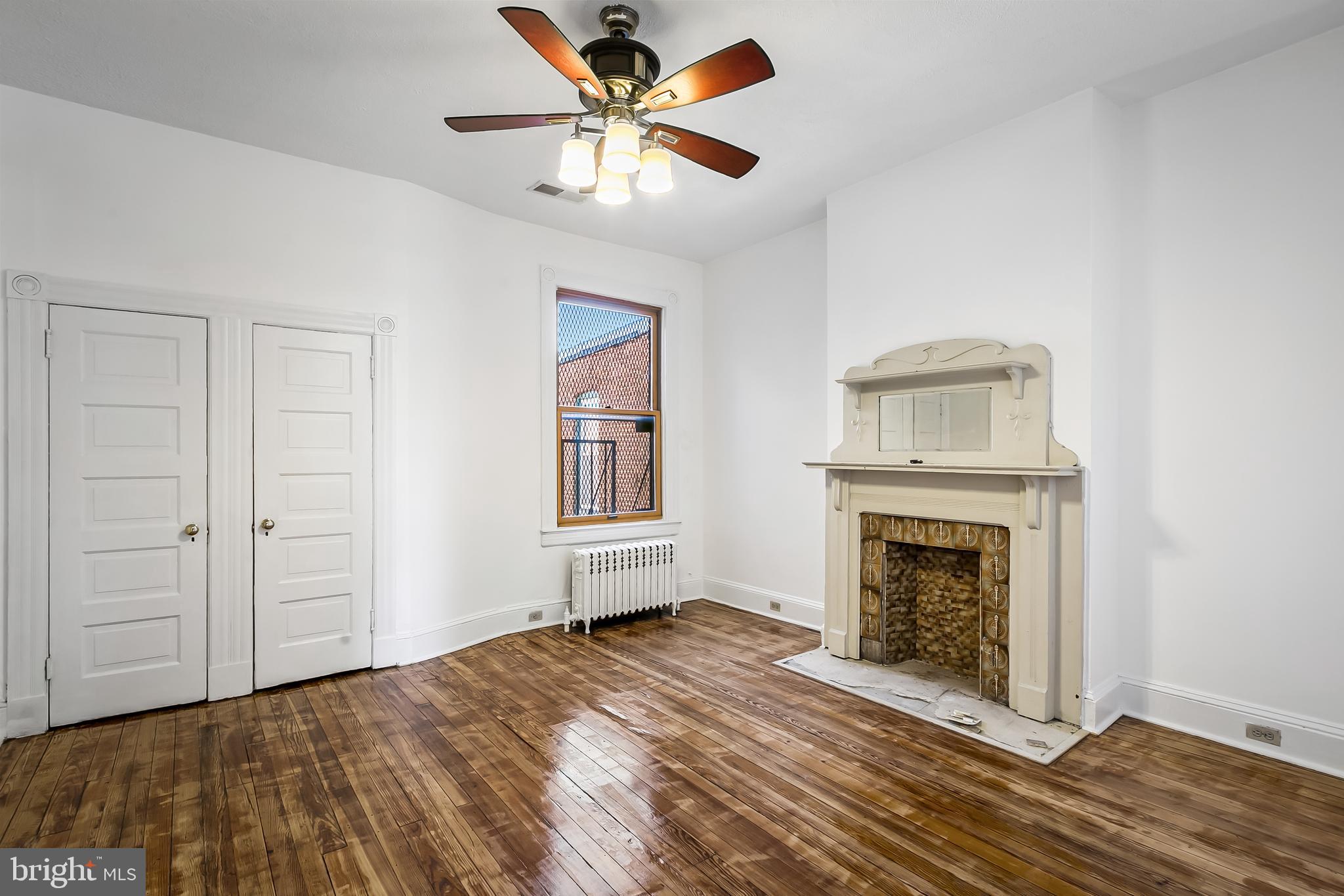 2243 Eutaw Place Baltimore, MD 21217 - Photo 44 of 54 a view of a livingroom with a fireplace a ceiling fan and wooden floor