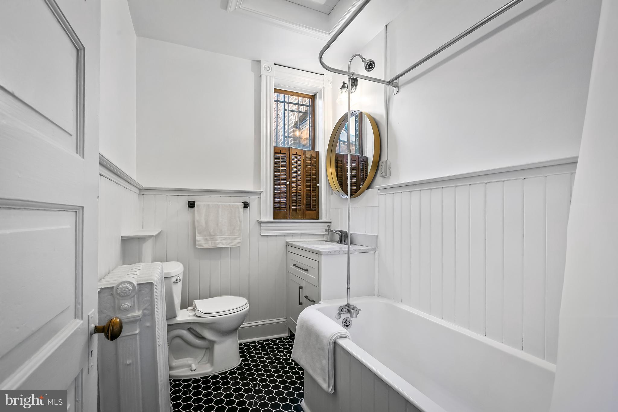 2243 Eutaw Place Baltimore, MD 21217 - Photo 46 of 54 a bathroom with a toilet a sink and a shower