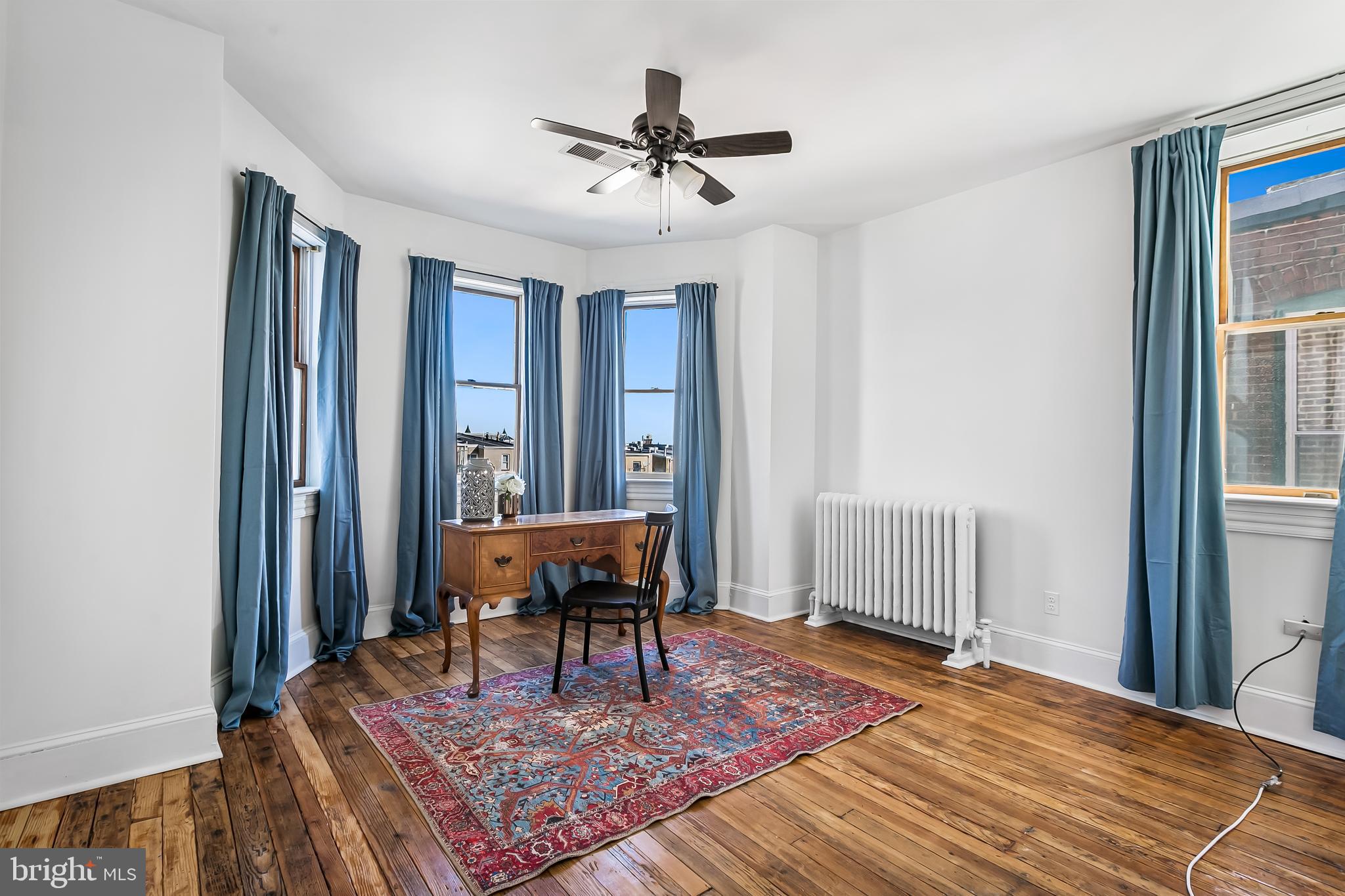 2243 Eutaw Place Baltimore, MD 21217 - Photo 47 of 54 a living room with furniture a table and a window