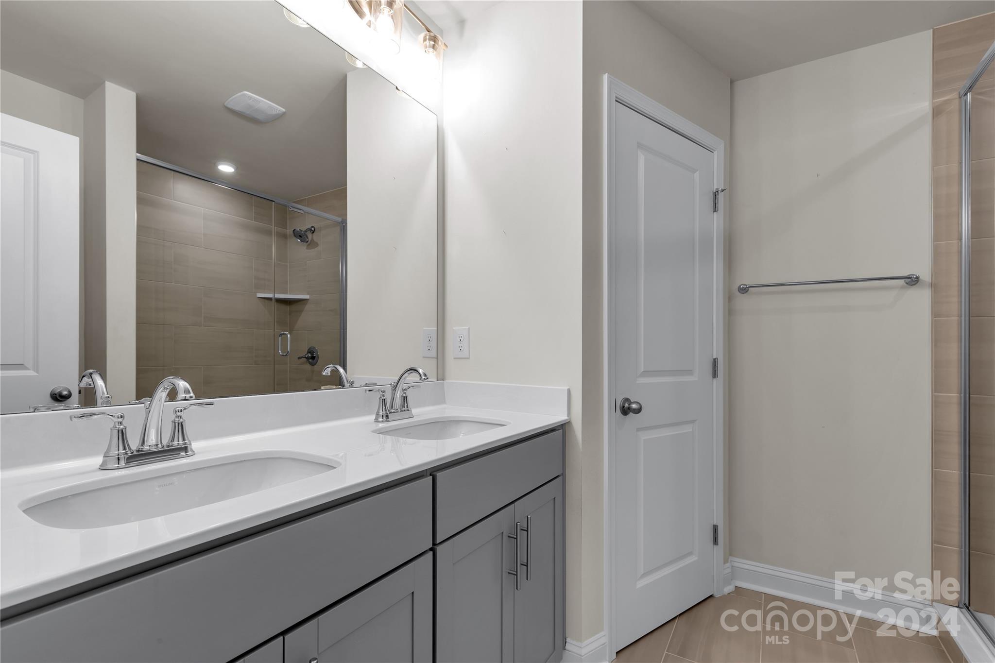 2026 Sutton View Road, Unit 693 Fort Mill, SC 29708 - Photo 16 of 26 a bathroom with a sink double vanity and a mirror