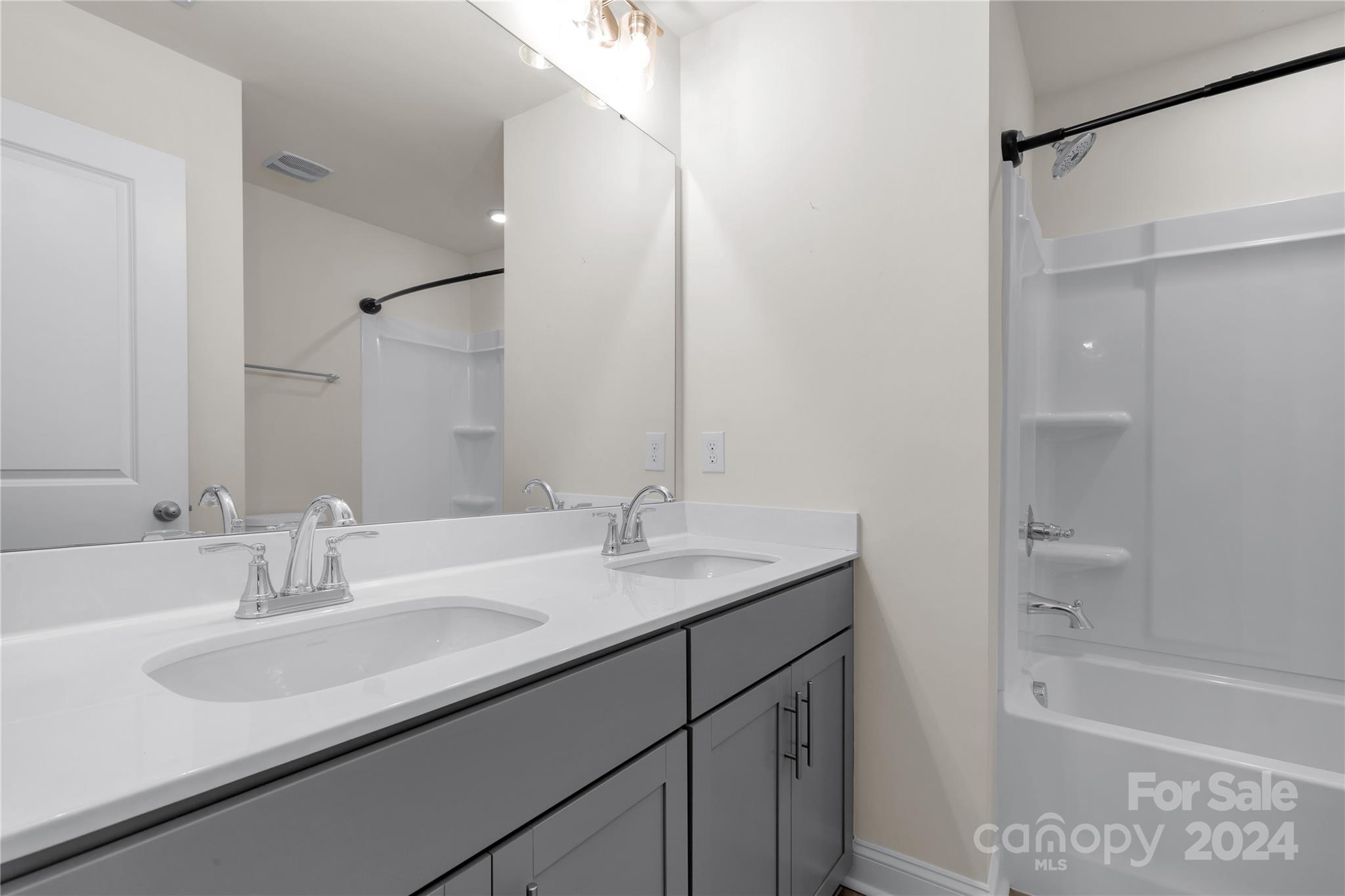 2026 Sutton View Road, Unit 693 Fort Mill, SC 29708 - Photo 22 of 26 a bathroom with a sink double vanity granite tub shower and a mirror