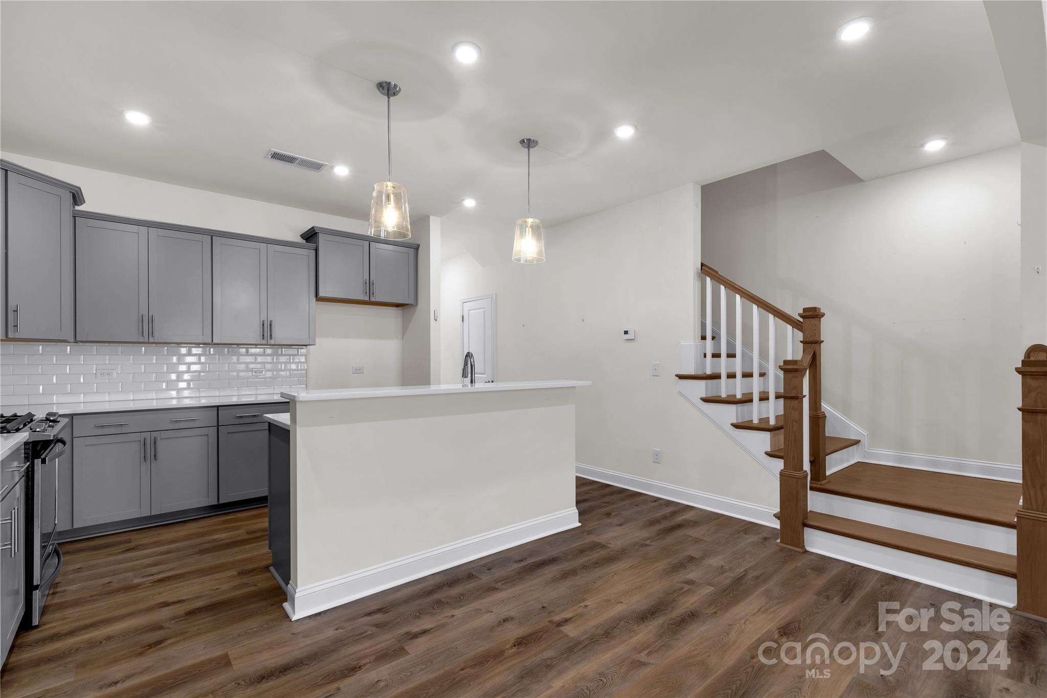 2026 Sutton View Road, Unit 693 Fort Mill, SC 29708 - Photo 5 of 26 a kitchen with a sink a refrigerator and wooden floor