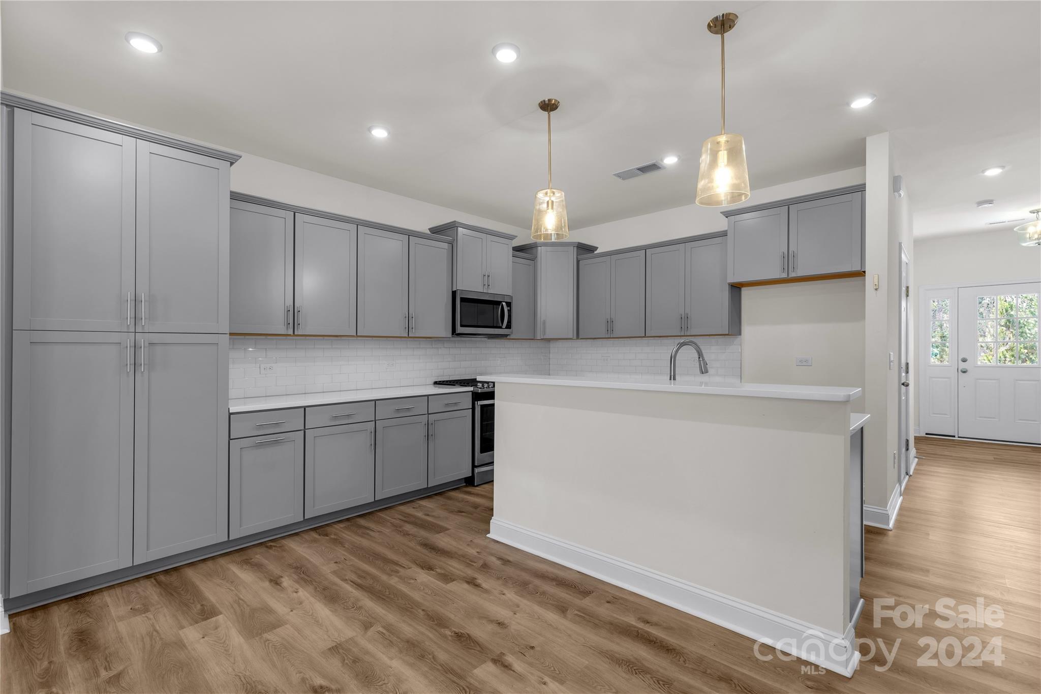 2026 Sutton View Road, Unit 693 Fort Mill, SC 29708 - Photo 6 of 26 a large kitchen with kitchen island a sink stainless steel appliances and cabinets