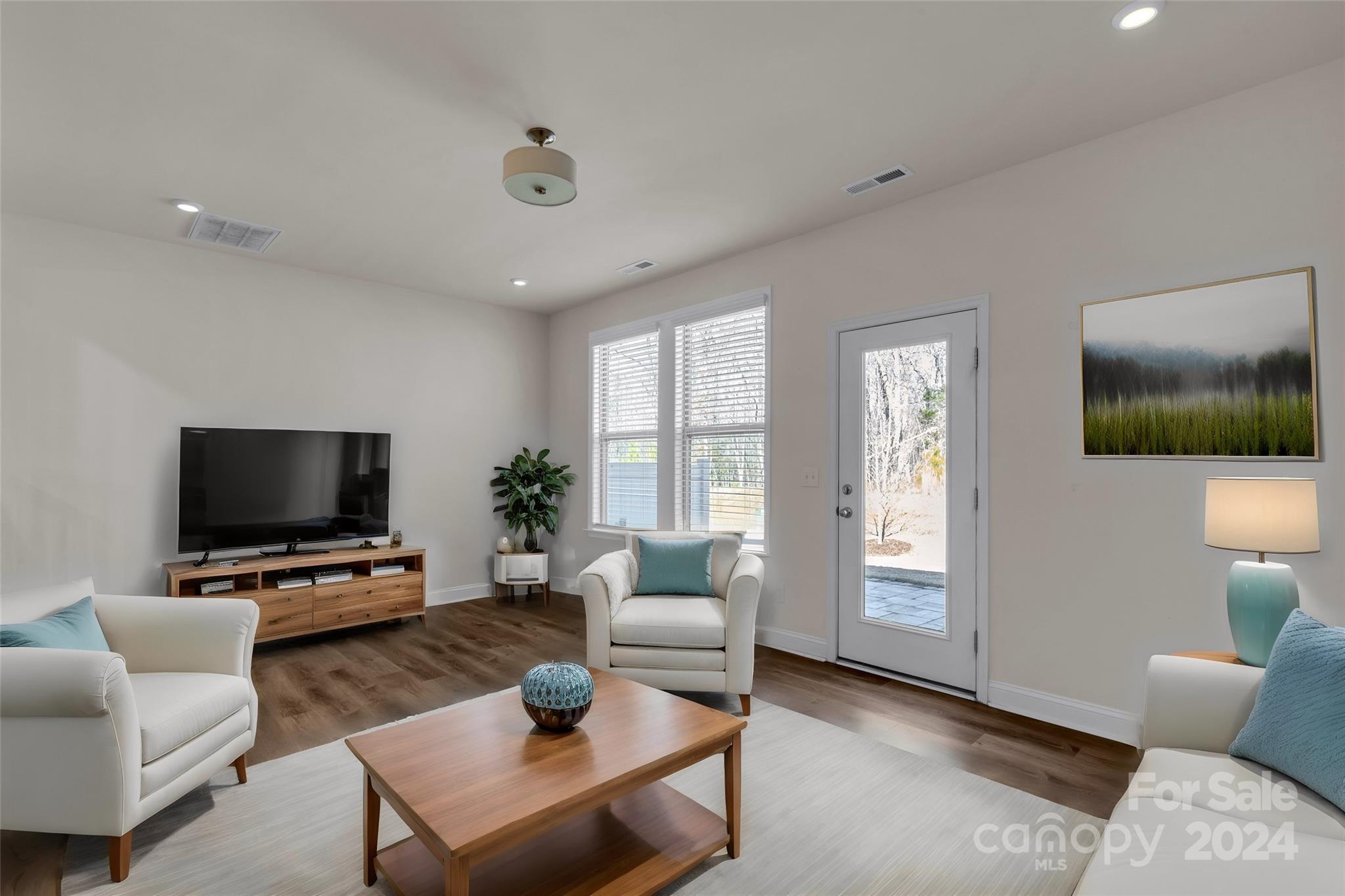 2026 Sutton View Road, Unit 693 Fort Mill, SC 29708 - Photo 10 of 26 a living room with furniture and a flat screen tv