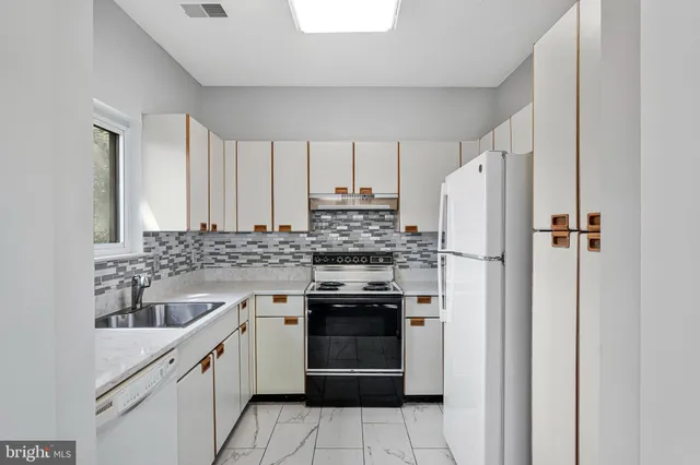 a kitchen with a stove sink and refrigerator