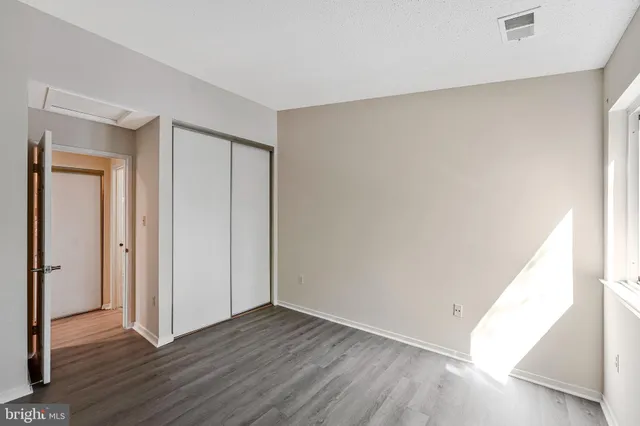 a view of an empty room and wooden floor