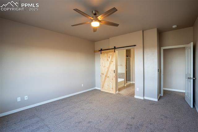 1985 Reed Grass Way Colorado Springs, CO 80915 - Photo 10 of 36 Primary bedroom with adjoining 5 piece bath and walk in closet (main floor)