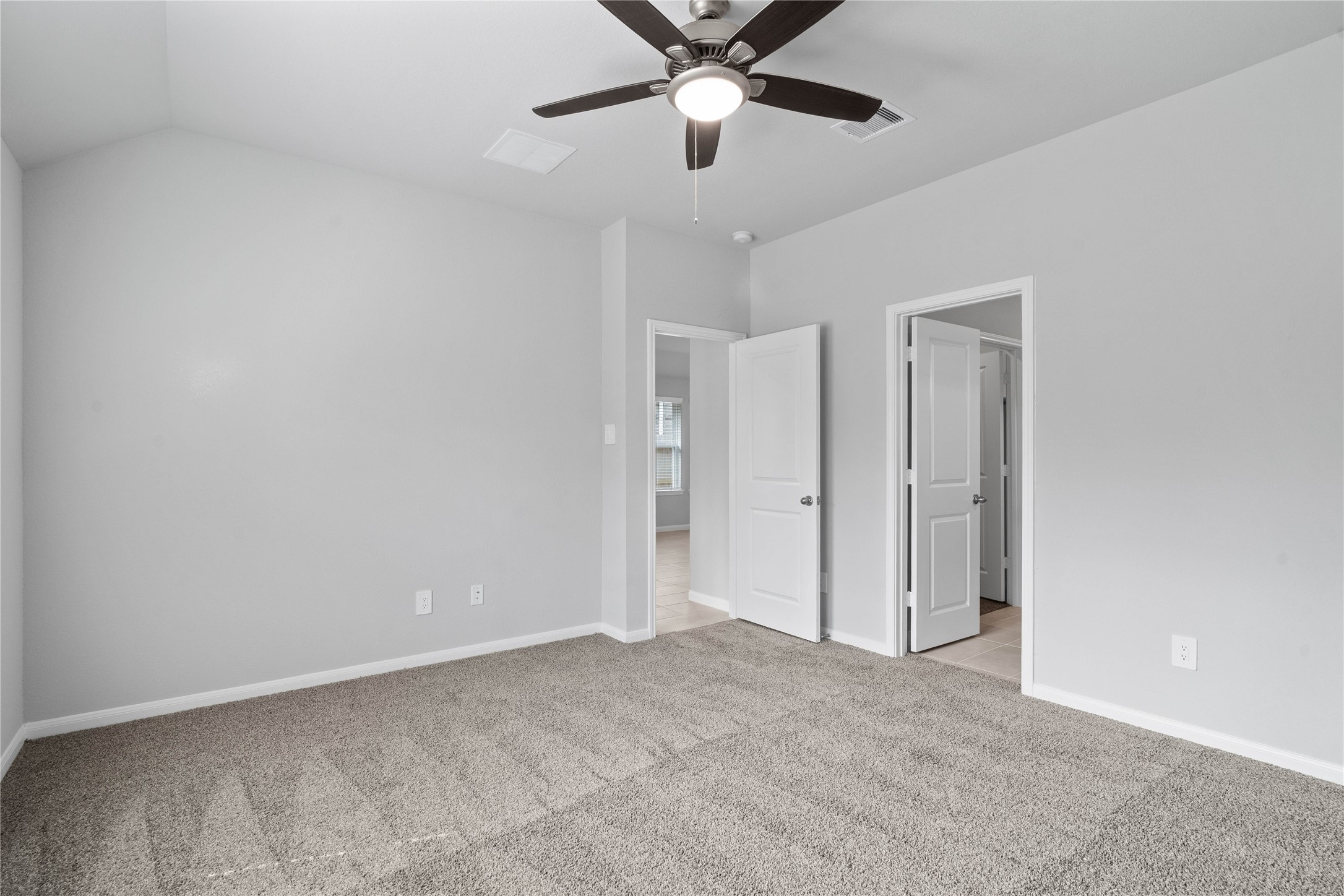 19555 Montgomery Rdg Way Montgomery, TX 77316 - Photo 27 of 38 The private primary suite efficiently connects the sleeping area with the dedicated bathroom and generous closet.