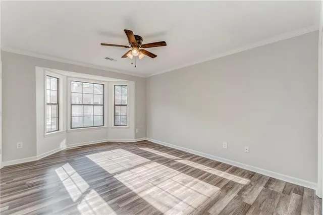 a view of a room with wooden floor and windows