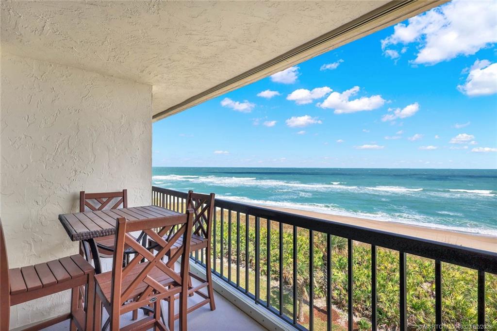 10680 South Ocean Drive, Unit 408 Jensen Beach, FL 34957 - Photo 1 of 43 a view of a swimming pool with an outdoor seating