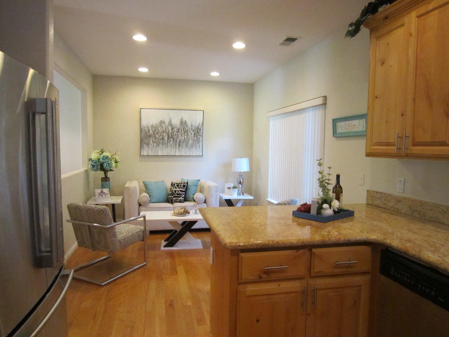2381 Homestead Road Santa Clara, CA 95050 - Photo 12 of 20 a view of a kitchen with kitchen island a stove a sink and a refrigerator