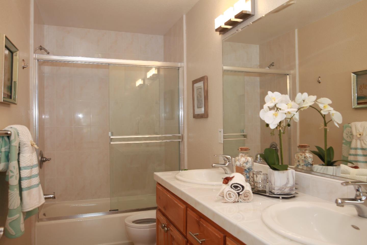 2381 Homestead Road Santa Clara, CA 95050 - Photo 8 of 20 a bathroom with a granite countertop sink a toilet and shower