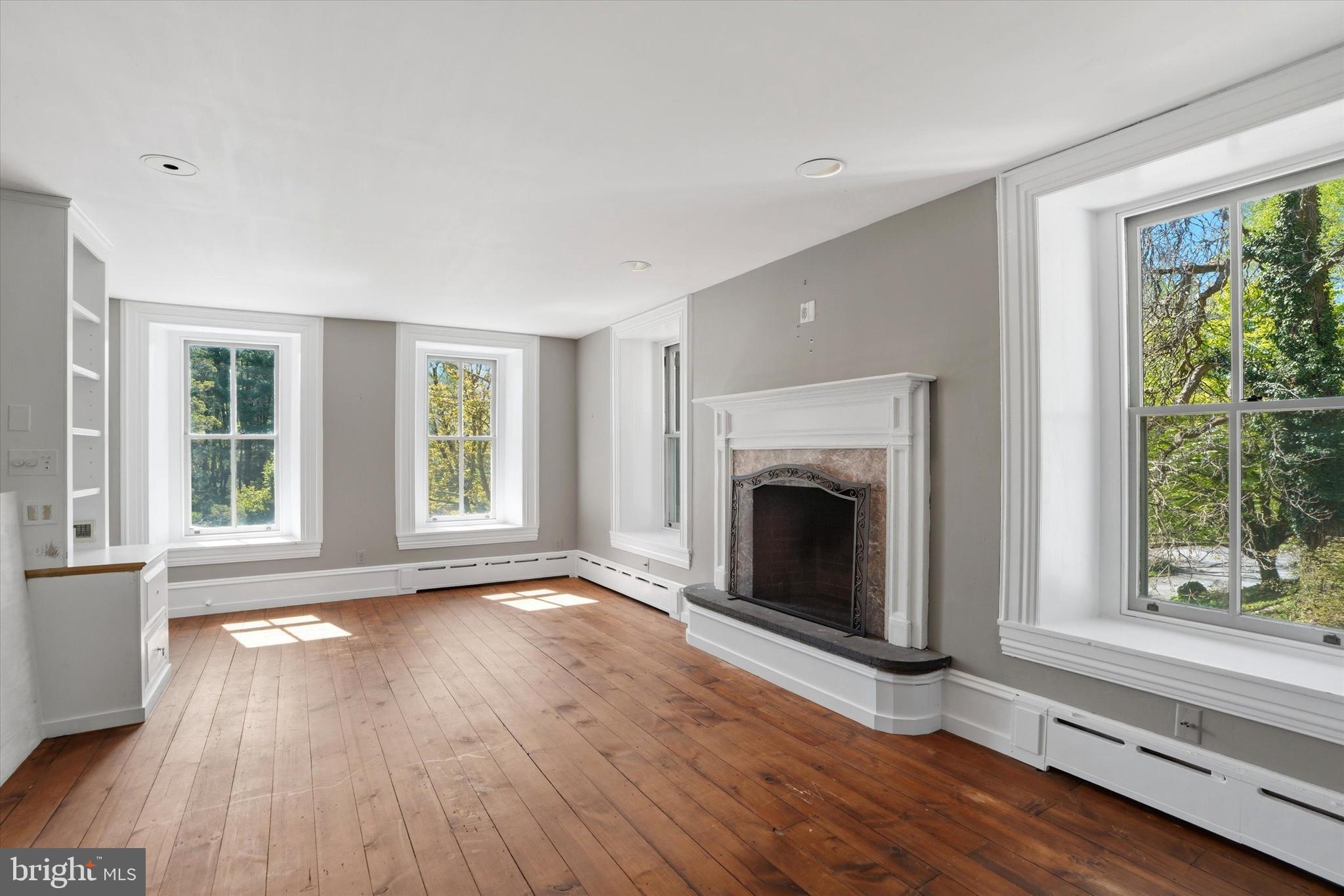 1451 Prizer Road Pottstown, PA 19465 - Photo 13 of 23 a view of an empty room with wooden floor and a window