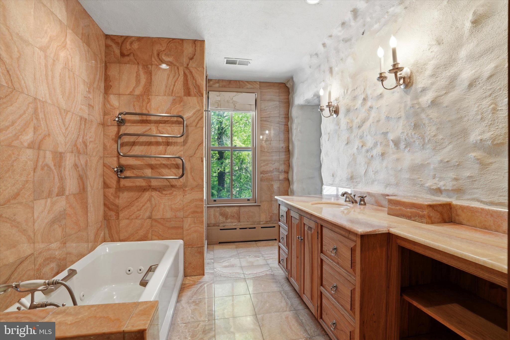 1451 Prizer Road Pottstown, PA 19465 - Photo 18 of 23 a bathroom with a granite countertop sink a mirror and a bathtub