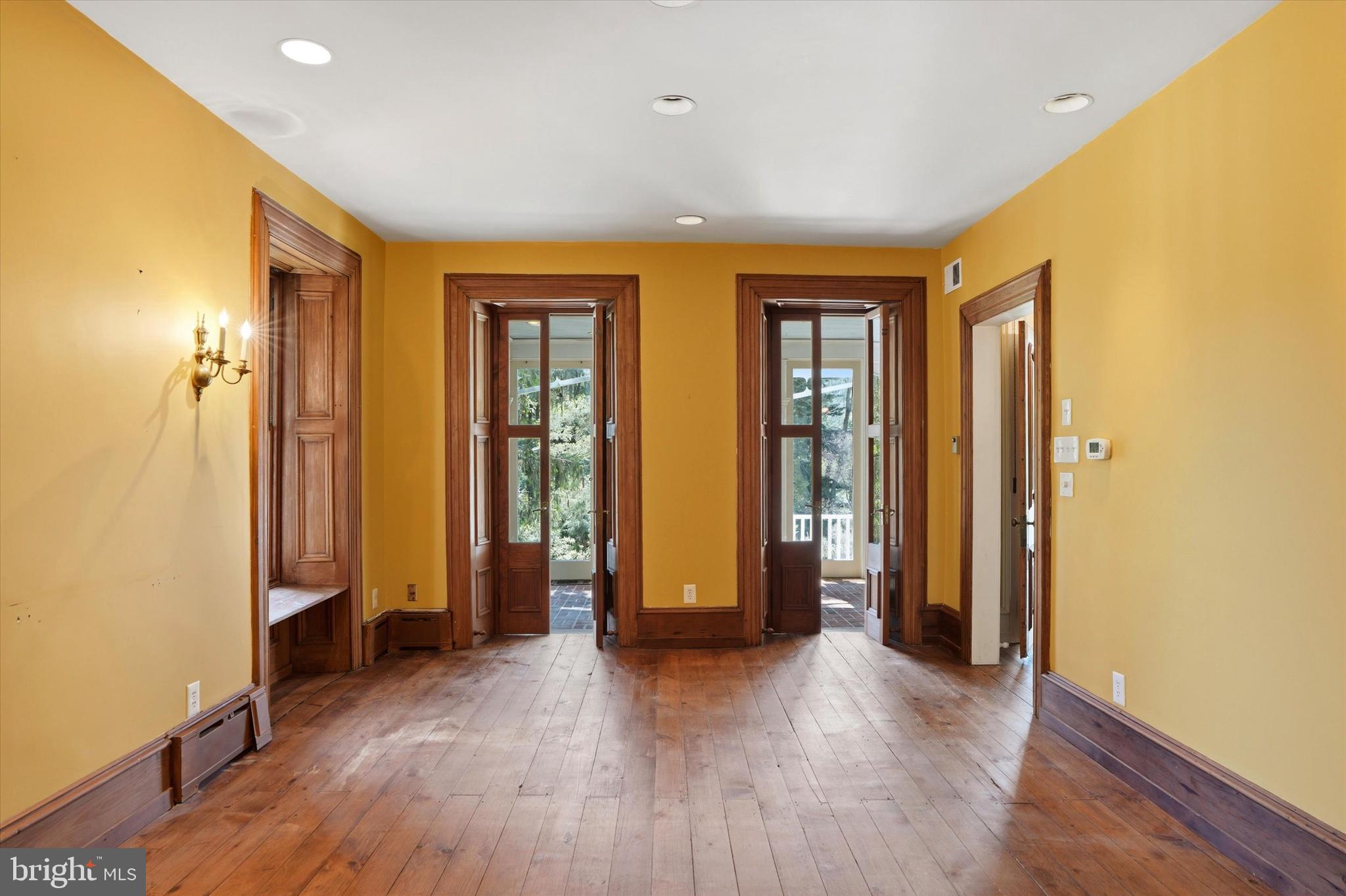 1451 Prizer Road Pottstown, PA 19465 - Photo 6 of 23 an empty room with wooden floor and windows