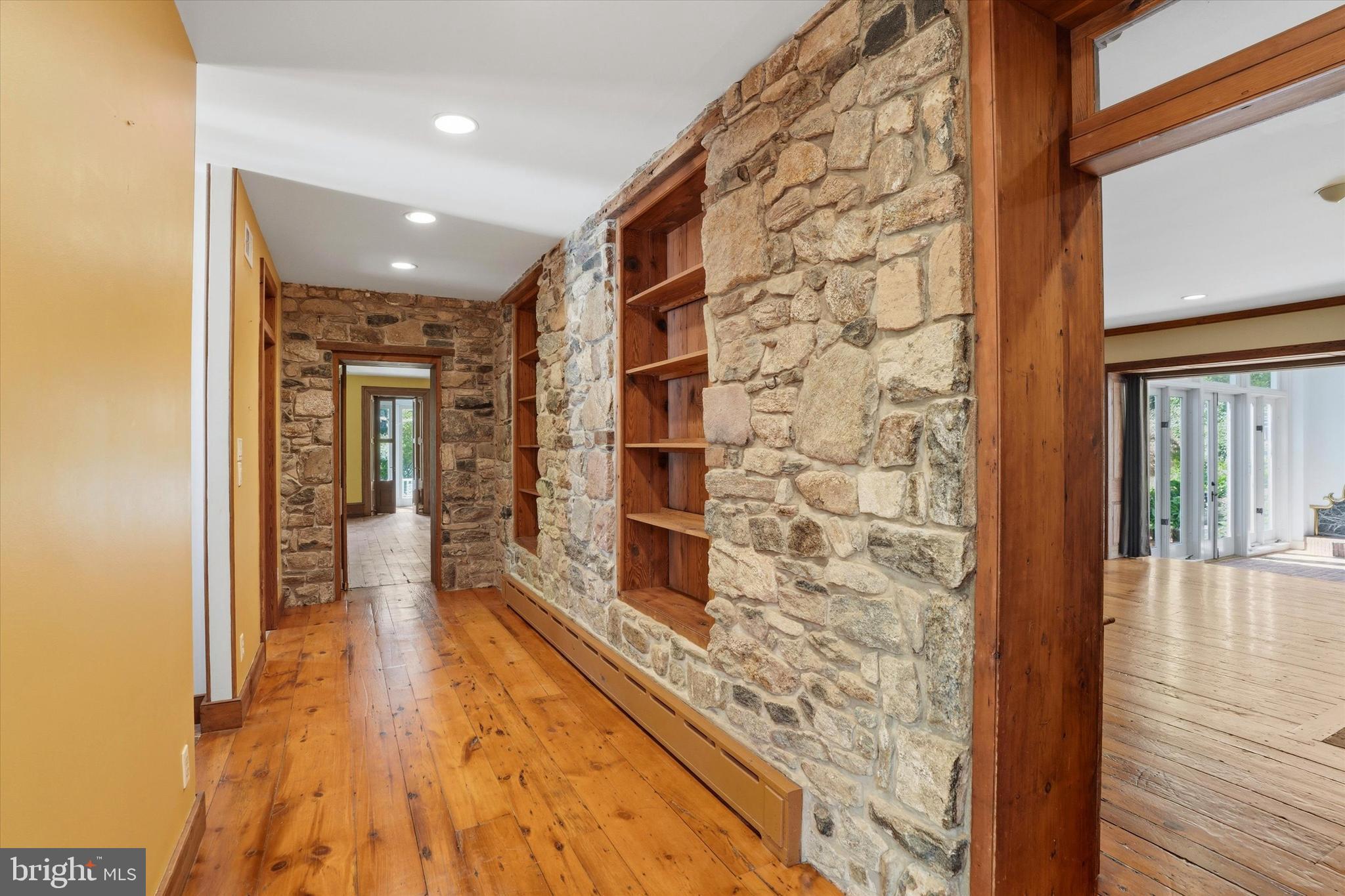 1451 Prizer Road Pottstown, PA 19465 - Photo 8 of 23 a hallway with a wooden floor and a bathroom view