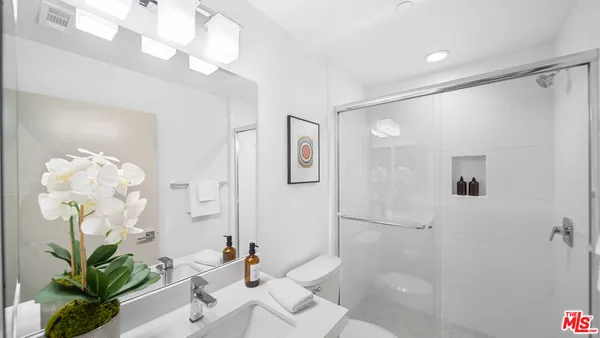 a bathroom with a tub sink and mirror