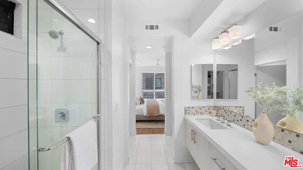 a bathroom with a sink vanity and a mirror