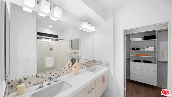 a bathroom with a sink mirror and toilet