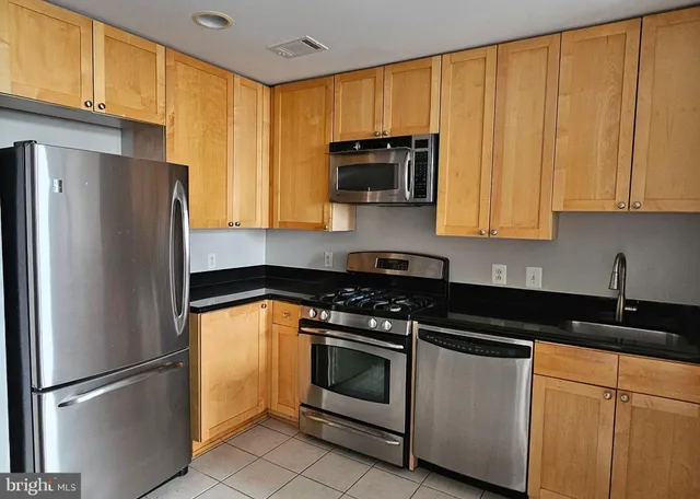 a kitchen with a refrigerator sink and microwave