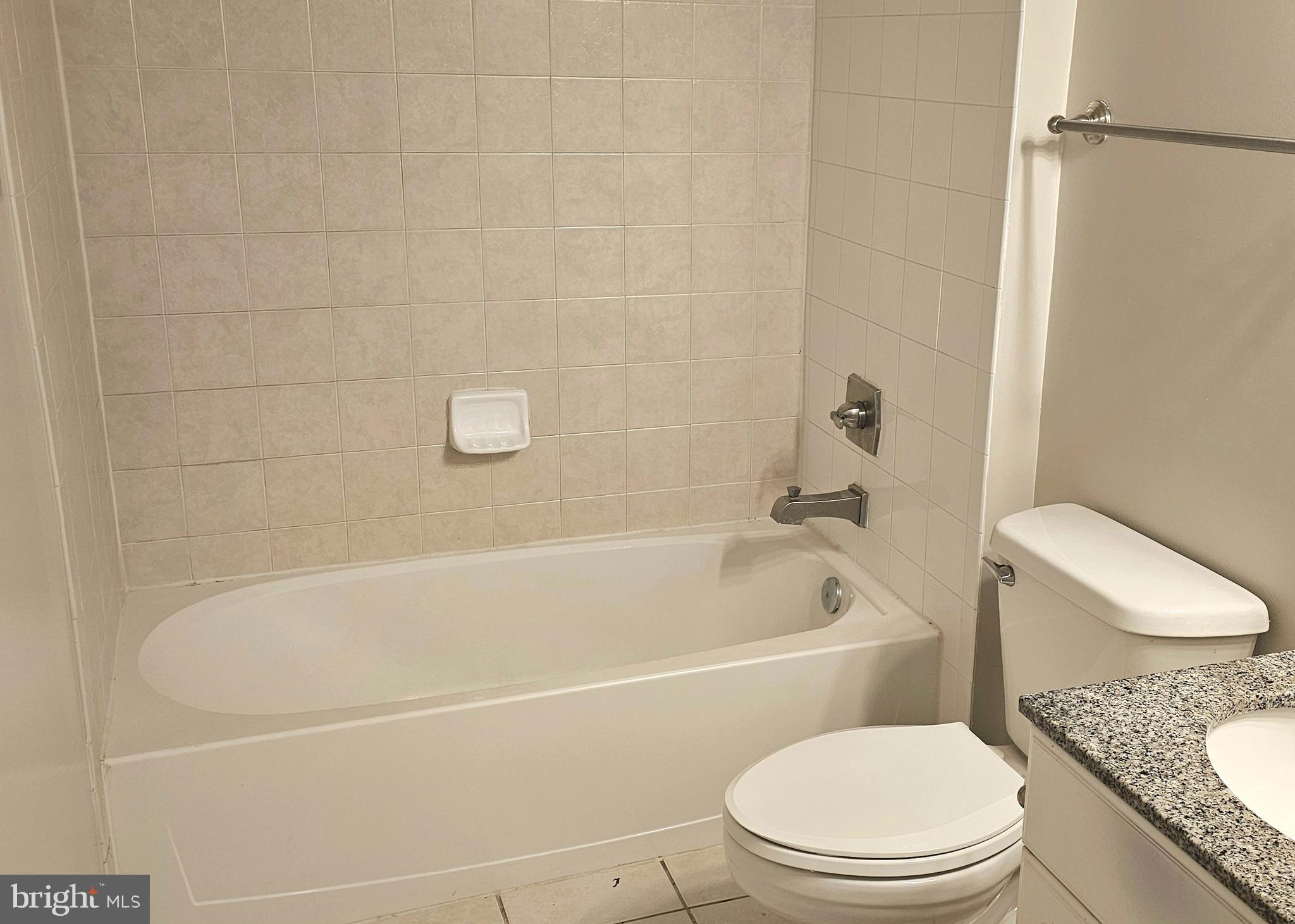 3600 South Glebe Road, Unit 330W Arlington, VA 22202 - Photo 18 of 34 a white toilet and tub sitting next to a bathroom sink