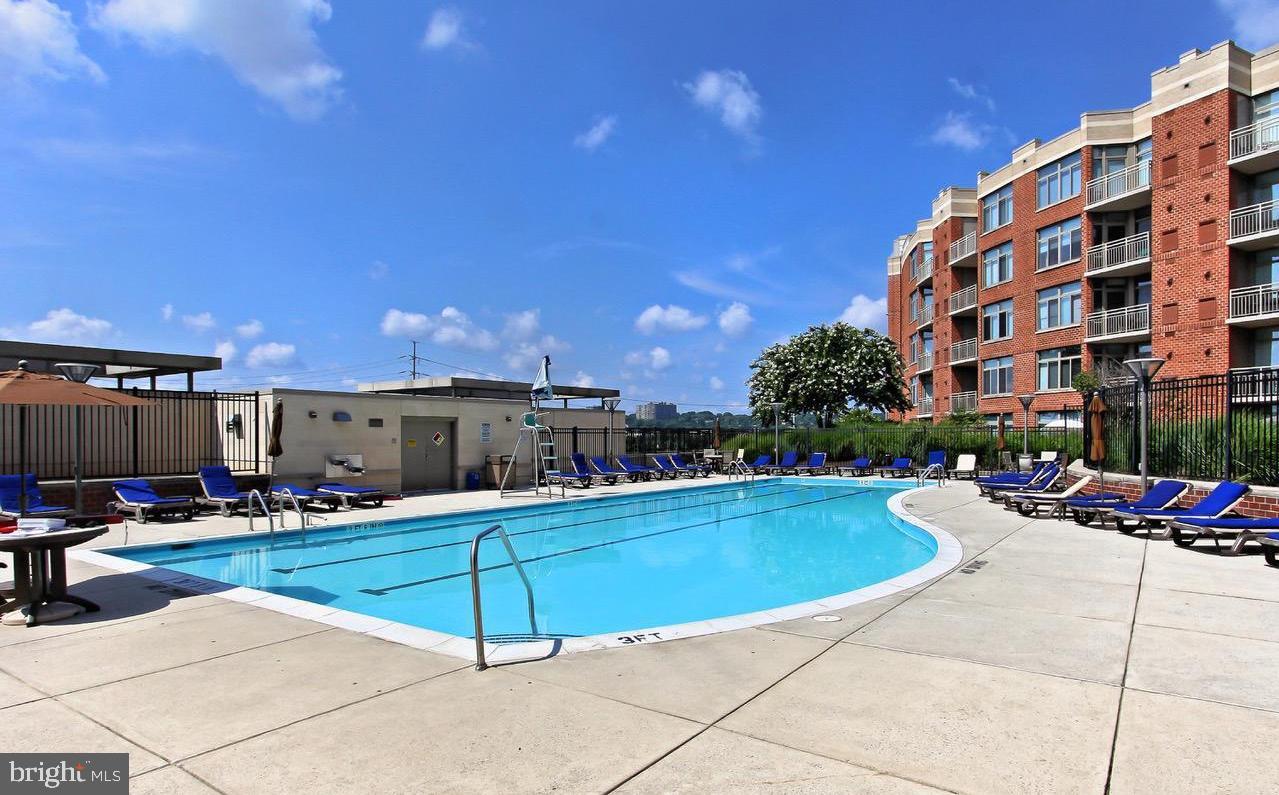 3600 South Glebe Road, Unit 330W Arlington, VA 22202 - Photo 24 of 34 a swimming pool with outdoor seating and yard