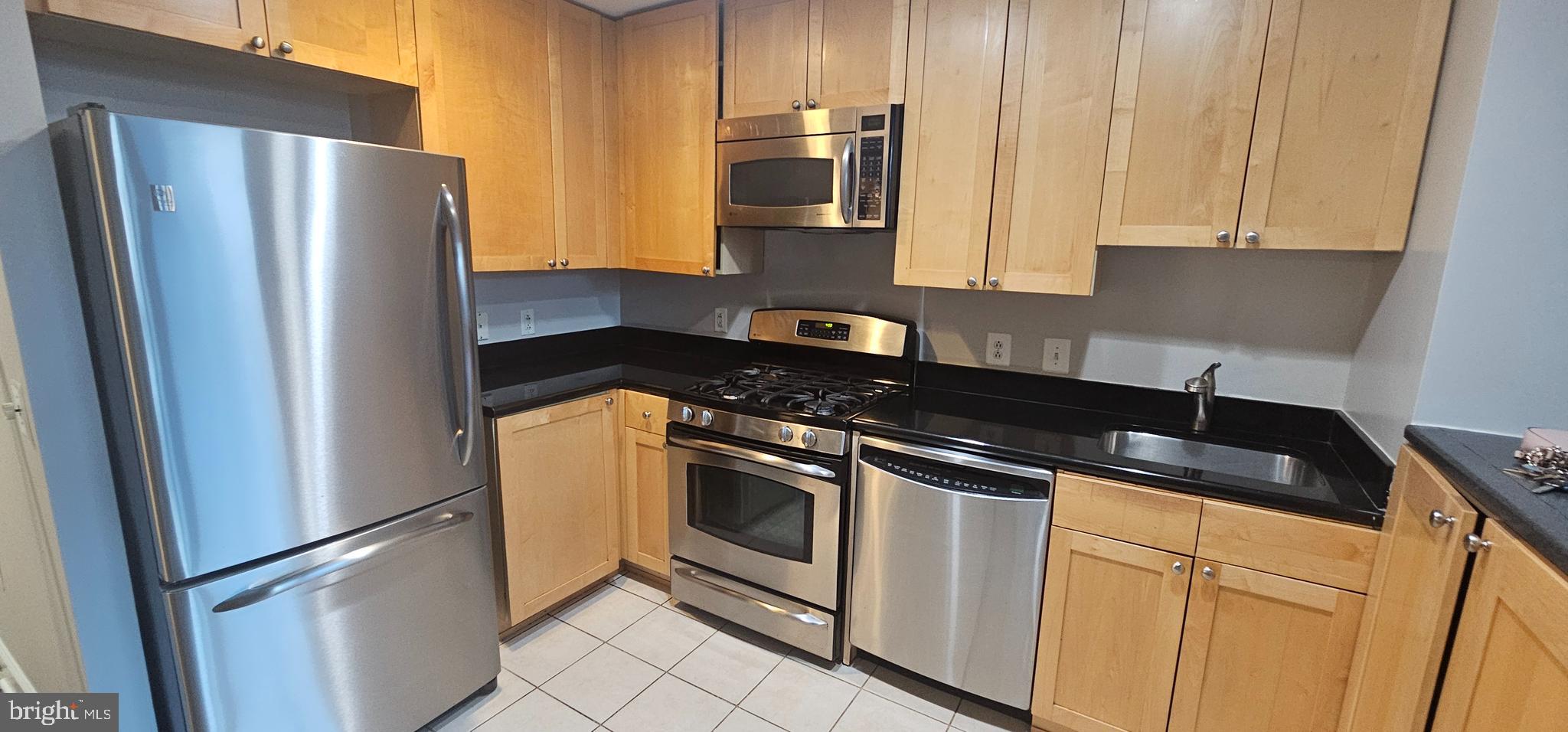 3600 South Glebe Road, Unit 330W Arlington, VA 22202 - Photo 10 of 34 a kitchen with stainless steel appliances granite countertop a refrigerator a stove and a sink