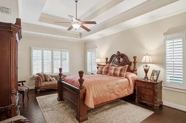 a bedroom with a bed and ceiling fan